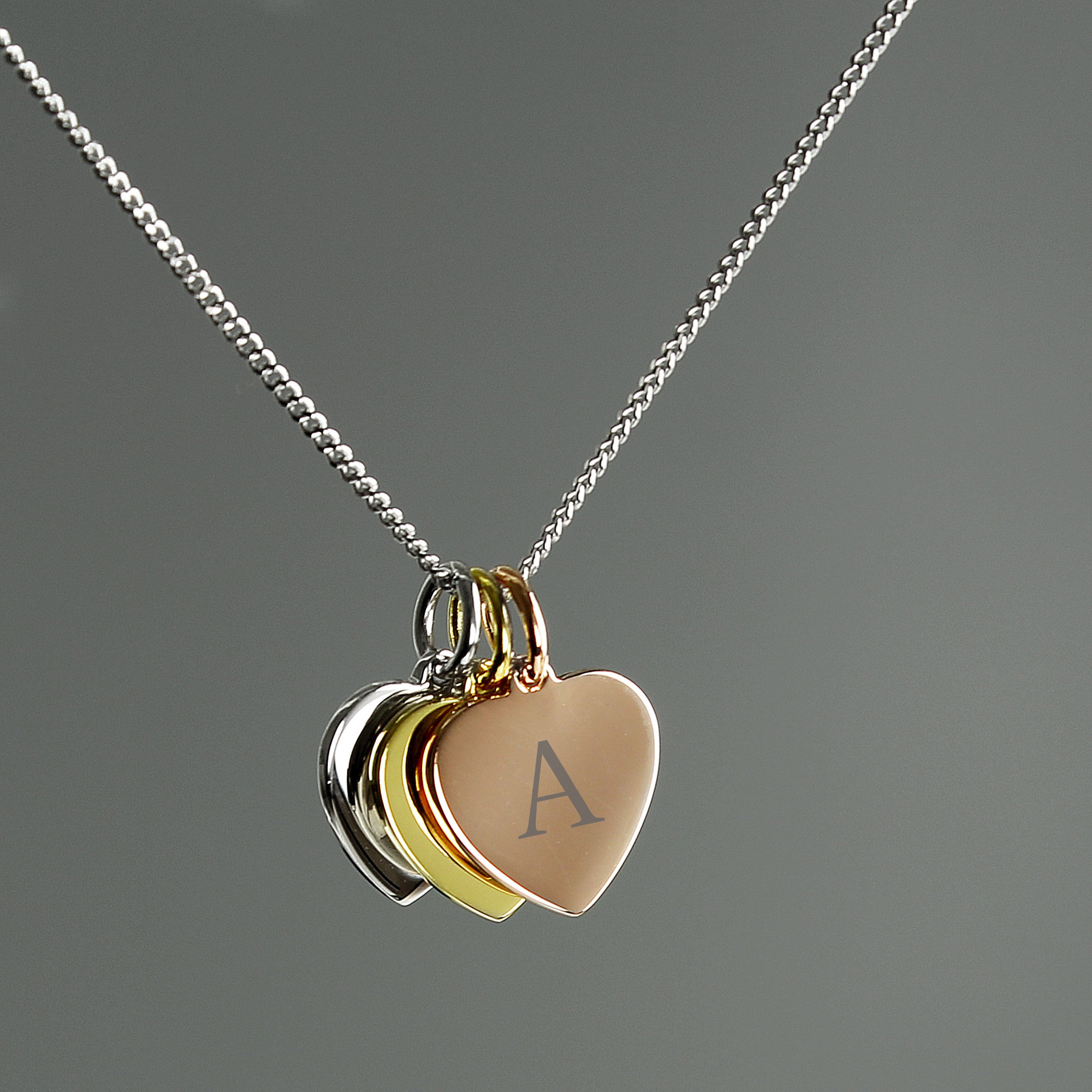 Personalised Initials Gold Rose Gold and Silver Three Hearts Necklace With Grey Background