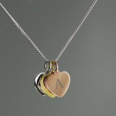 Personalised Initials Gold Rose Gold and Silver Three Hearts Necklace With Grey Background
