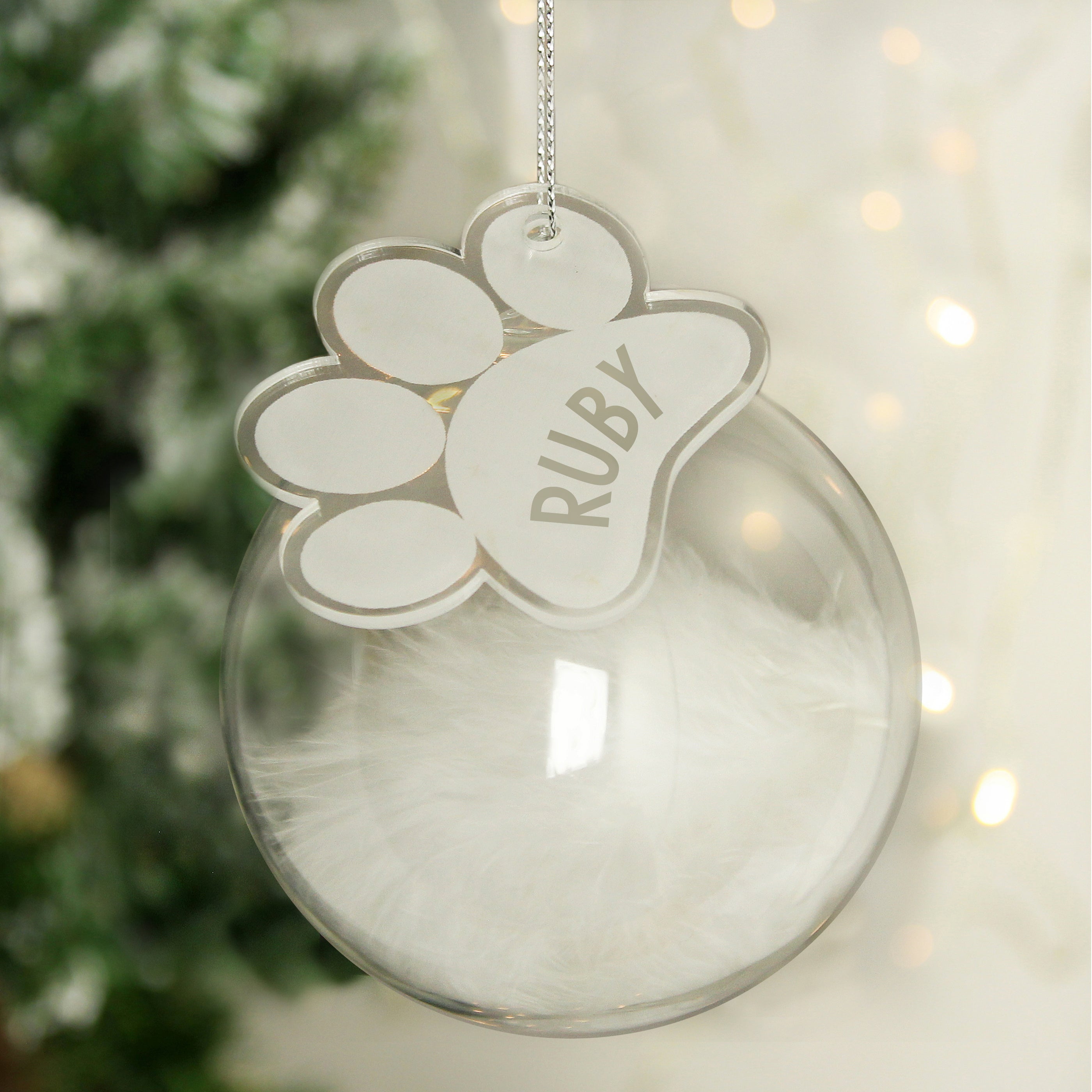 Personalised Pets White Feather Glass Bauble With Paw Print Tag Hanging From A Tree