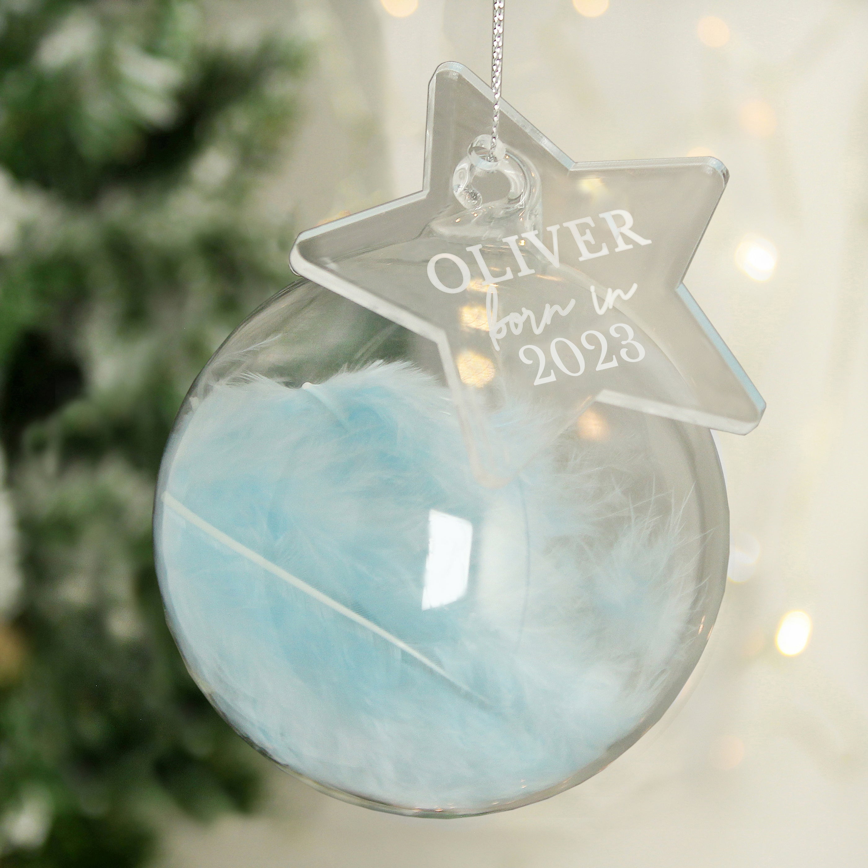 This feather glass bauble with star tag will make a stunning addition to the Christmas tree for baby's first Christmas.