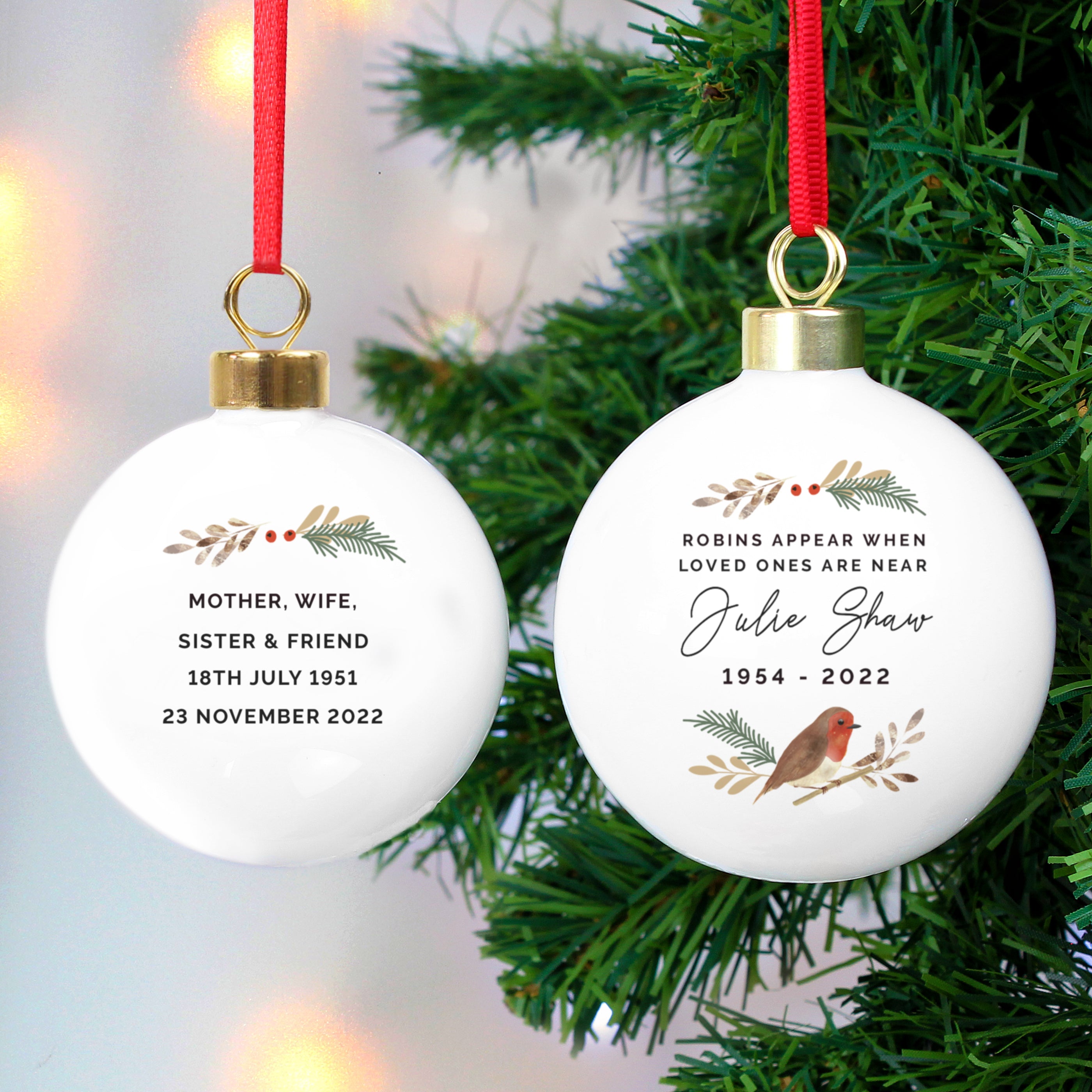 Personalised Robin Bauble Hanging From A Christmas Tree